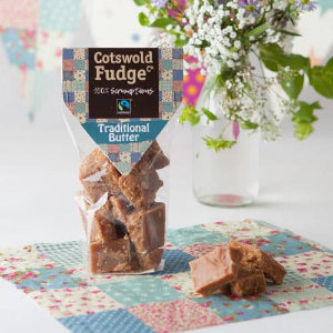 Cotswold Fudge packaging with fudge pieces on a colorful patchwork tablecloth.